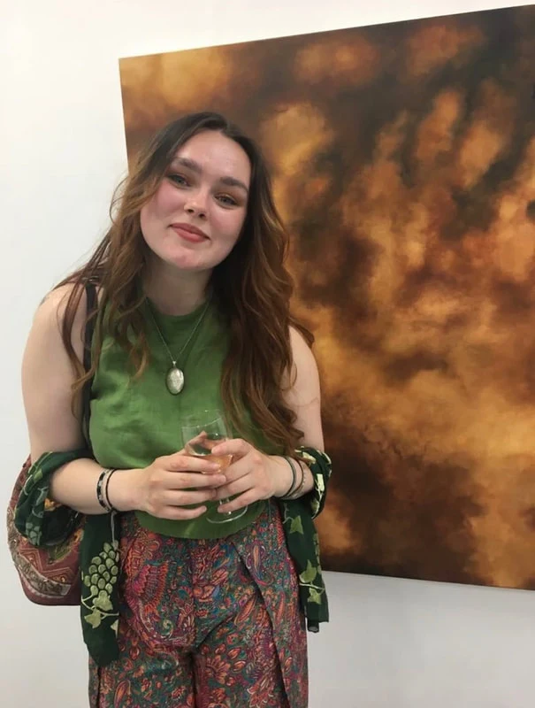 Emily McLatchie with her earth pigment paintings